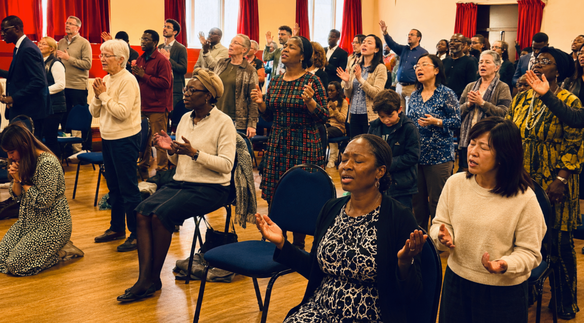 Resurrection Chapel congregation worshipping with hands raised